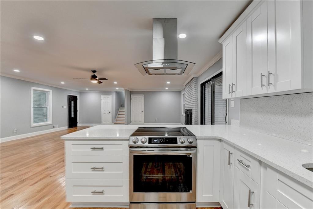 5169 Oxbow Road Stone Mountain, GA 30087 - Photo 18 of 58 a kitchen with granite countertop a stove and cabinets