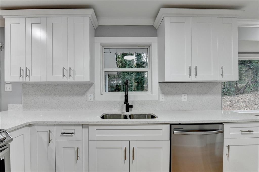5169 Oxbow Road Stone Mountain, GA 30087 - Photo 19 of 58 a kitchen with white cabinets and a window