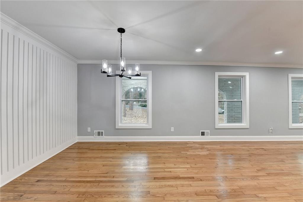 5169 Oxbow Road Stone Mountain, GA 30087 - Photo 22 of 58 an empty room with wooden floor and windows