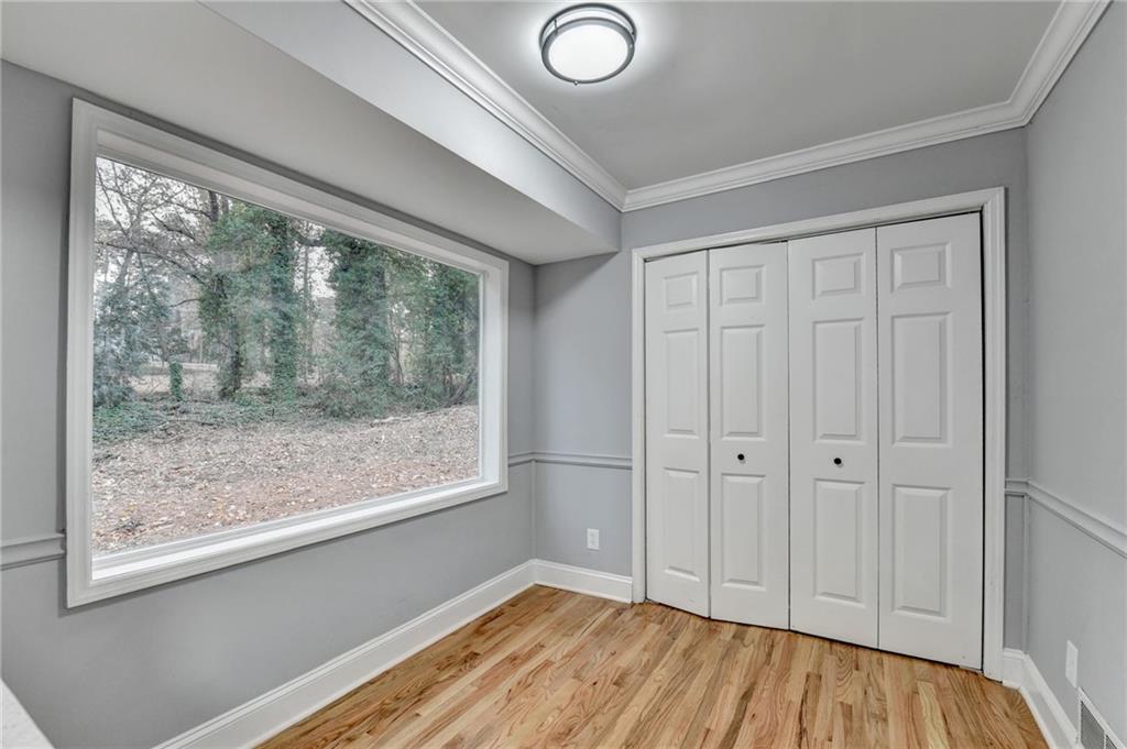 5169 Oxbow Road Stone Mountain, GA 30087 - Photo 23 of 58 a view of empty room with wooden floor and fan