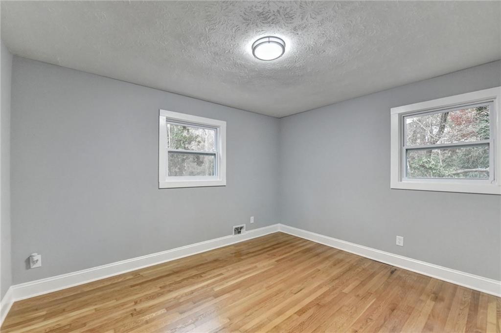 5169 Oxbow Road Stone Mountain, GA 30087 - Photo 32 of 58 a view of empty room with window and wooden floor