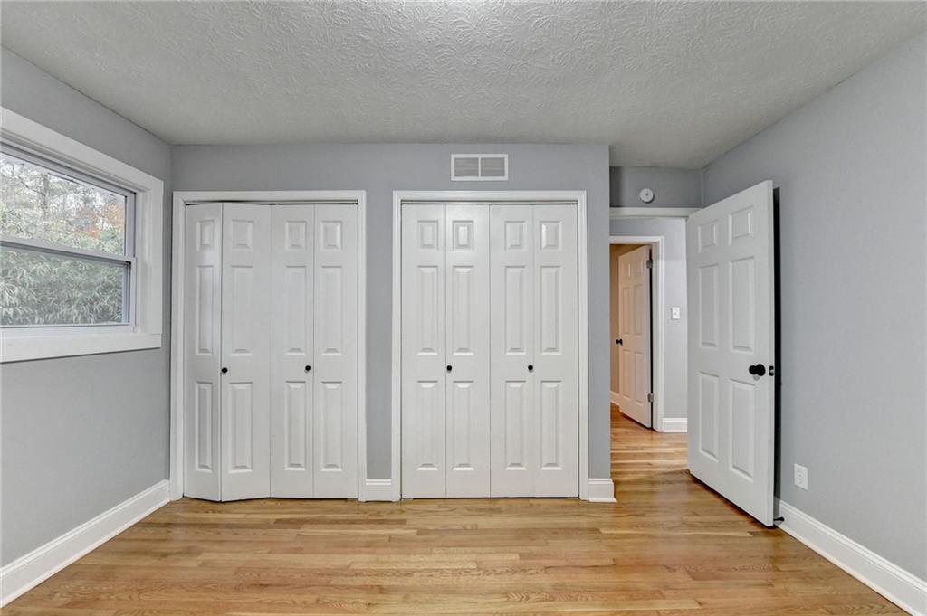 5169 Oxbow Road Stone Mountain, GA 30087 - Photo 35 of 58 a view of an empty room with wooden floor and a window