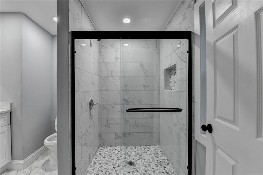 5169 Oxbow Road Stone Mountain, GA 30087 - Photo 42 of 58 a bathroom with a shower and a toilet
