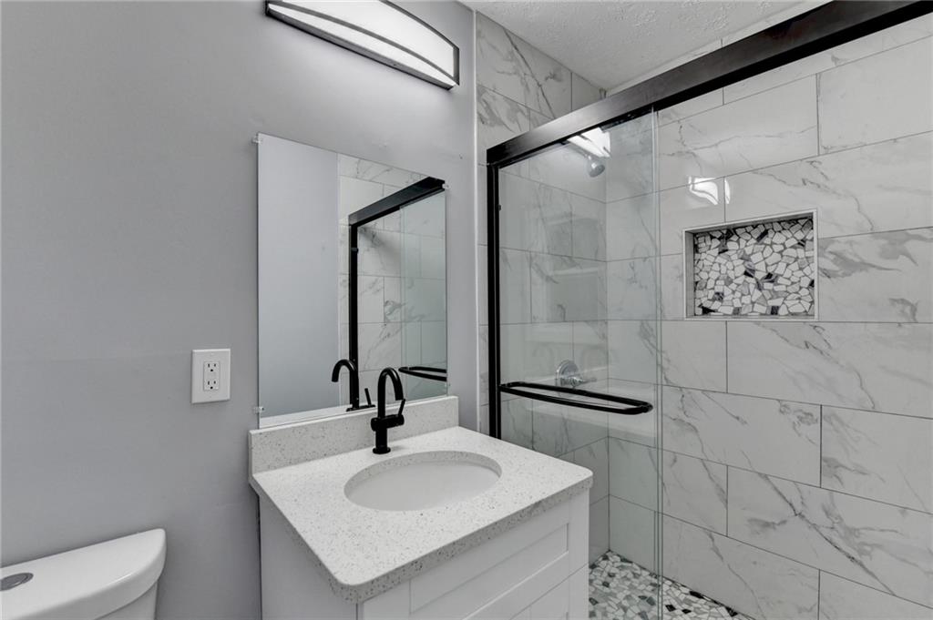 5169 Oxbow Road Stone Mountain, GA 30087 - Photo 43 of 58 a bathroom with a sink toilet and mirror