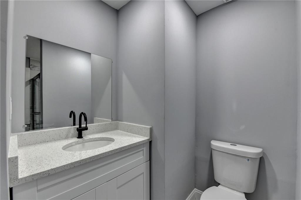 5169 Oxbow Road Stone Mountain, GA 30087 - Photo 45 of 58 a bathroom with a sink toilet and mirror