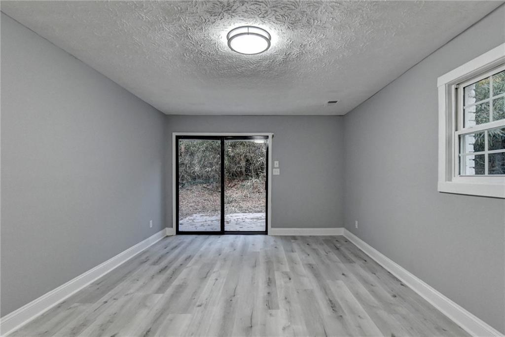 5169 Oxbow Road Stone Mountain, GA 30087 - Photo 47 of 58 an empty room with wooden floor and windows