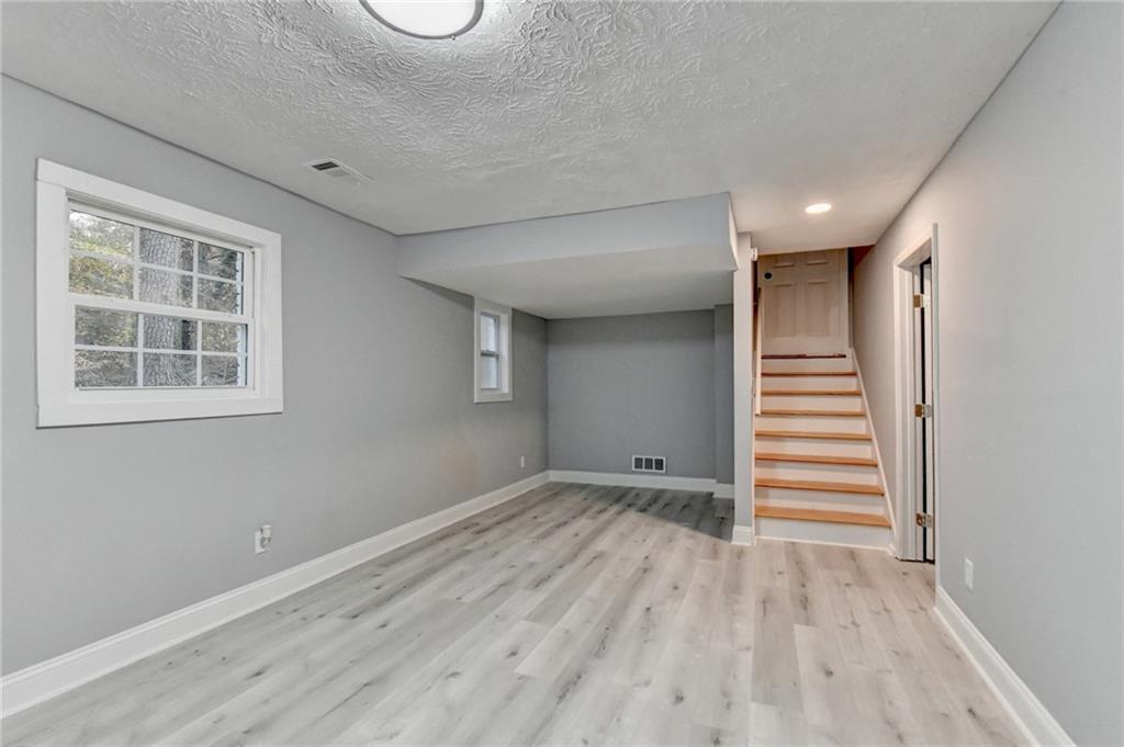 5169 Oxbow Road Stone Mountain, GA 30087 - Photo 48 of 58 a view of wooden floor and windows in a room