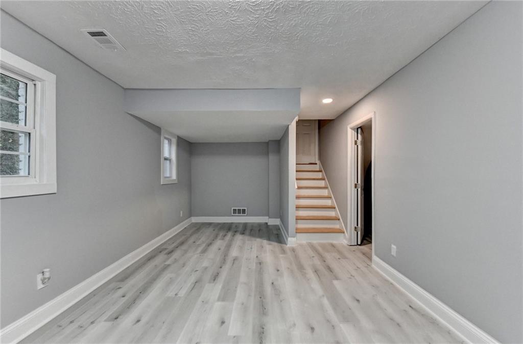 5169 Oxbow Road Stone Mountain, GA 30087 - Photo 49 of 58 a view of room with stairs and wooden floor