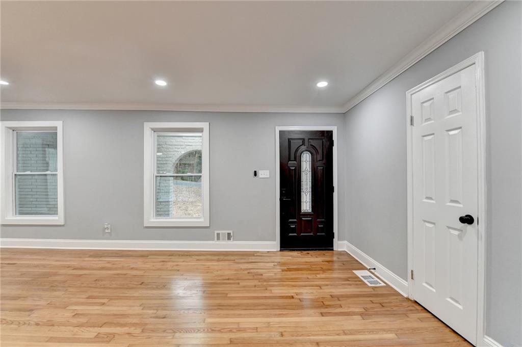 5169 Oxbow Road Stone Mountain, GA 30087 - Photo 5 of 58 a view of empty room with wooden floor and windows