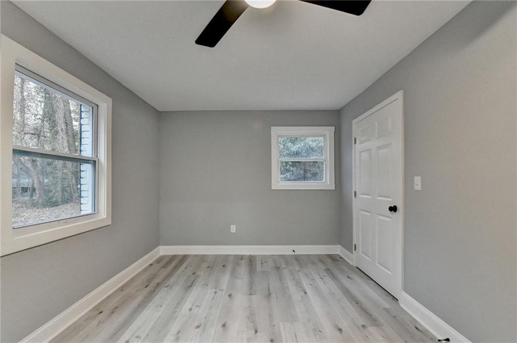 5169 Oxbow Road Stone Mountain, GA 30087 - Photo 51 of 58 a view of empty room with wooden floor and fan