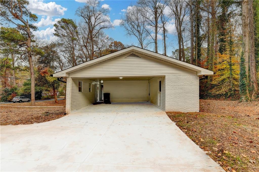 5169 Oxbow Road Stone Mountain, GA 30087 - Photo 52 of 58 a front view of a house with a yard and garage