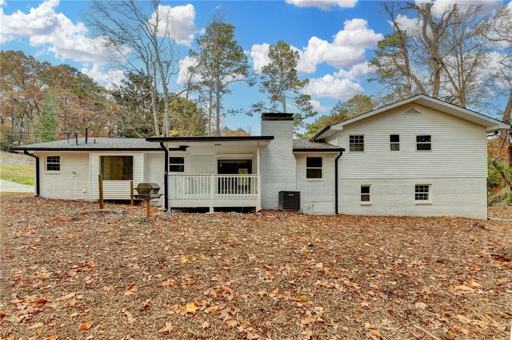 5169 Oxbow Road Stone Mountain, GA 30087 - Photo 55 of 58 a white house that has a tree in front of it