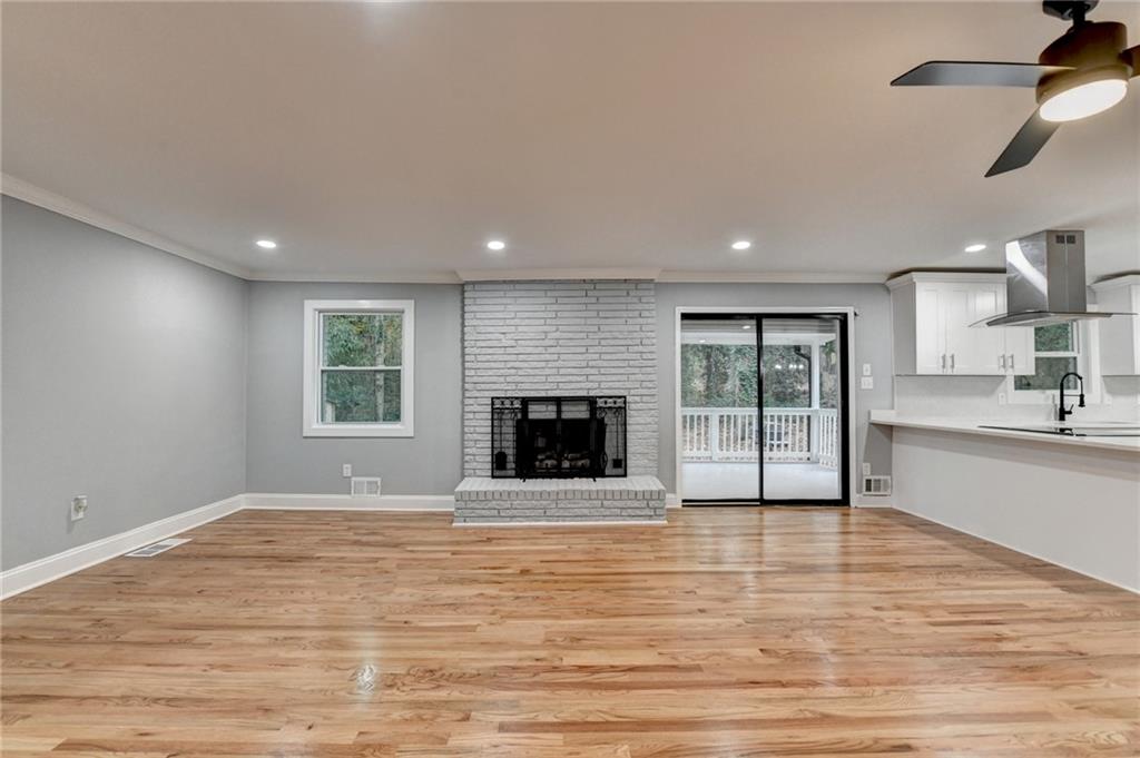 5169 Oxbow Road Stone Mountain, GA 30087 - Photo 8 of 58 a view of an empty room with a fireplace and a window