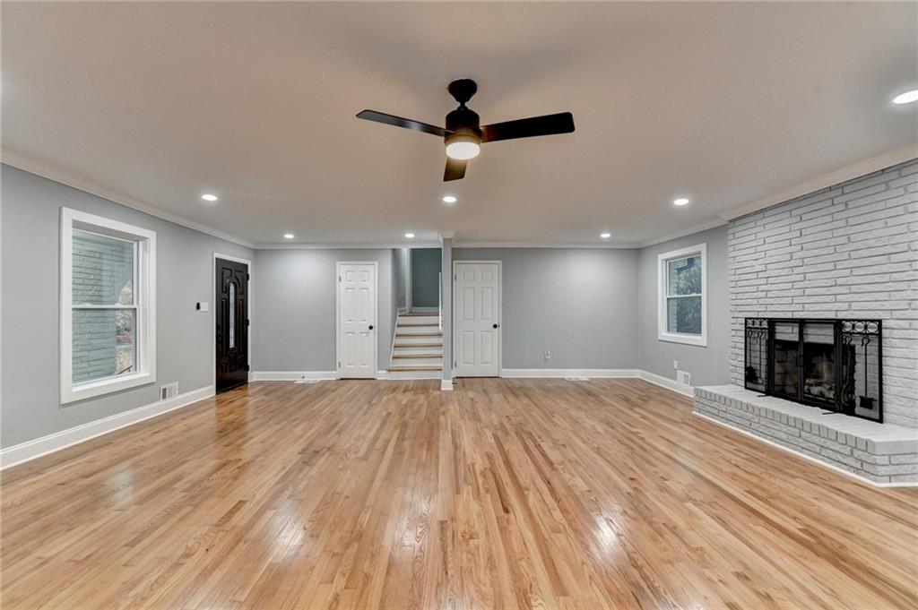 5169 Oxbow Road Stone Mountain, GA 30087 - Photo 9 of 58 a view of empty room with wooden floor and fireplace