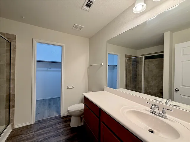 a bathroom with a sink a toilet and shower