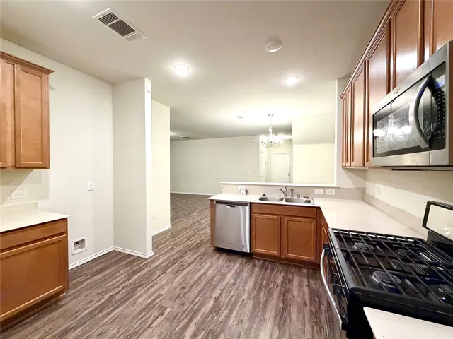 a kitchen with stainless steel appliances granite countertop a stove and a sink