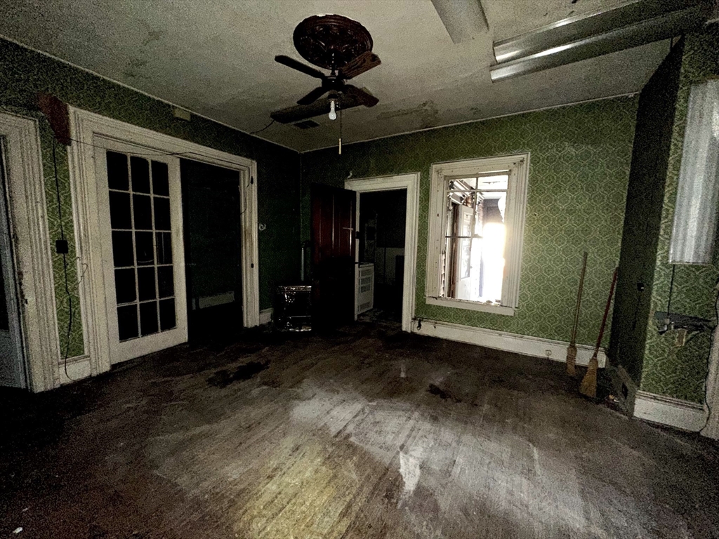 146 Bay Street Springfield, MA 01109 - Photo 11 of 39 a view of a livingroom with a ceiling fan and window