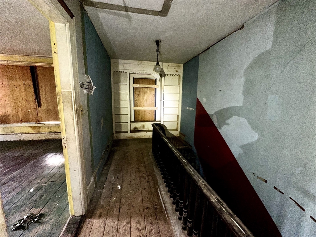 146 Bay Street Springfield, MA 01109 - Photo 18 of 39 a view of a hallway with wooden floor and staircase