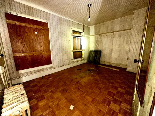 a view of an empty room with a fireplace