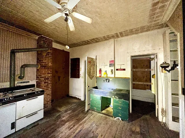 a kitchen with kitchen island a counter top space appliances and cabinets