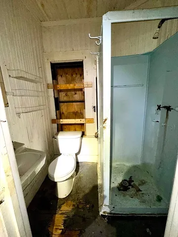 a bathroom with a granite countertop toilet and a sink