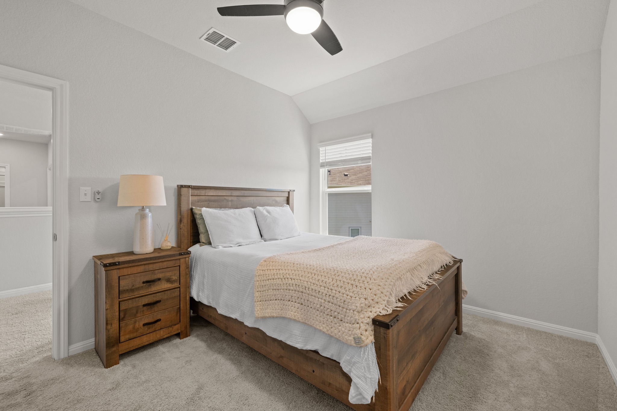 2049 Winston Way Leander, TX 78641 - Photo 19 of 35 Secondary bedroom #3 with vaulted ceiling, ceiling fan, walk-in closet and ensuite bath.
