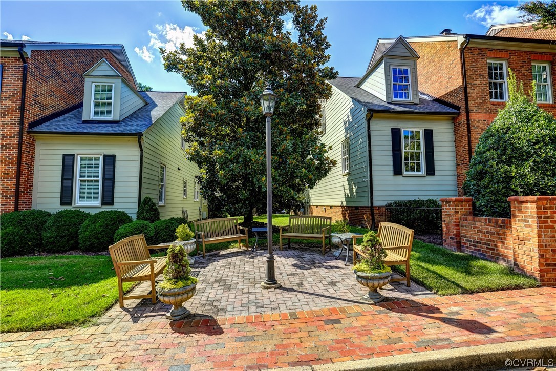 505 St Albans Way Henrico, VA 23229 - Photo 5 of 36 a view of a brick house with chairs and table in a patio