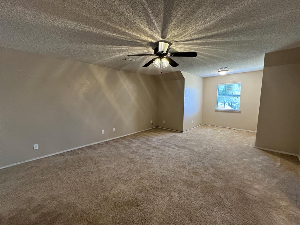 2202 Carriage Estates Road Sherman, TX 75092 - Photo 12 of 18 en empty room with windows and fan
