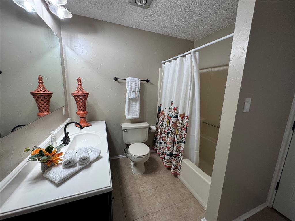 2202 Carriage Estates Road Sherman, TX 75092 - Photo 13 of 18 a bathroom with a sink toilet and shower