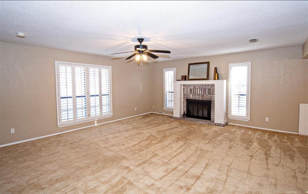 2202 Carriage Estates Road Sherman, TX 75092 - Photo 3 of 18 a view of an empty room with a fireplace and a window