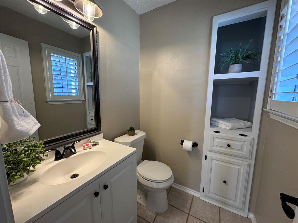 2202 Carriage Estates Road Sherman, TX 75092 - Photo 6 of 18 a bathroom with a sink vanity mirror and toilet