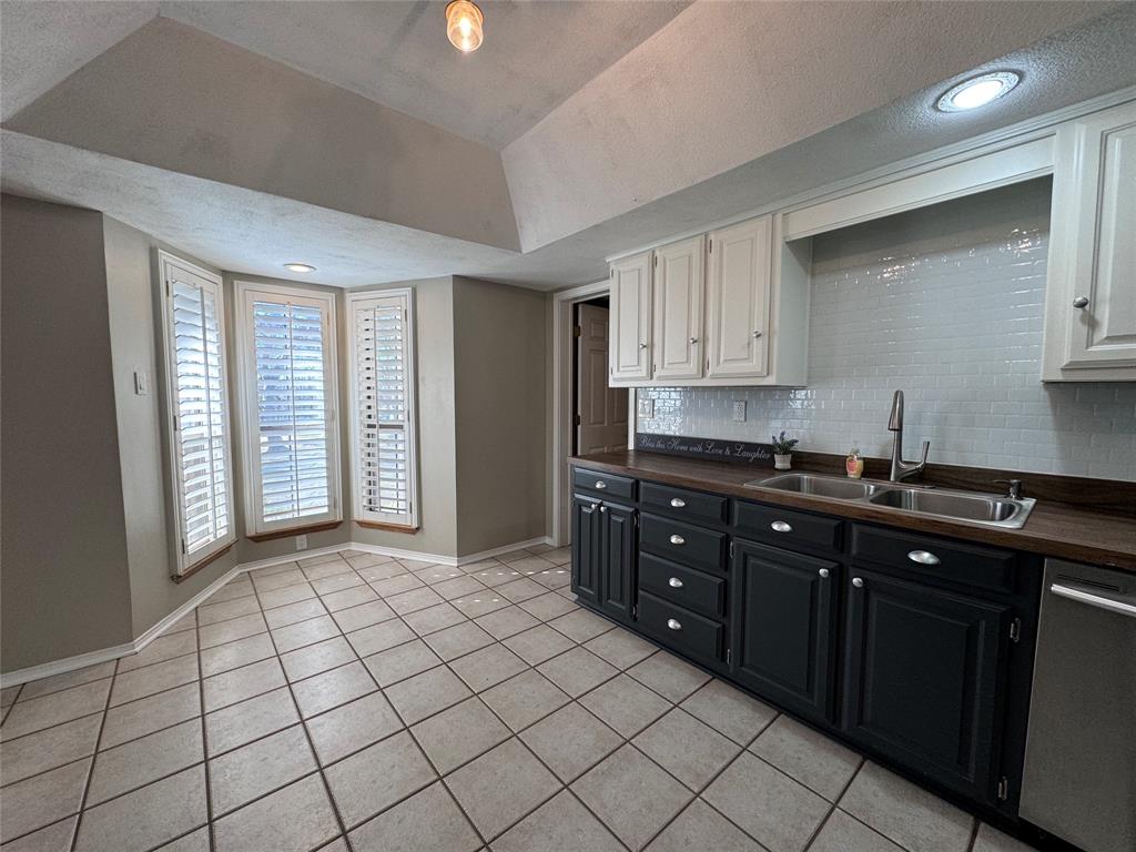 2202 Carriage Estates Road Sherman, TX 75092 - Photo 8 of 18 a kitchen with a sink and cabinets
