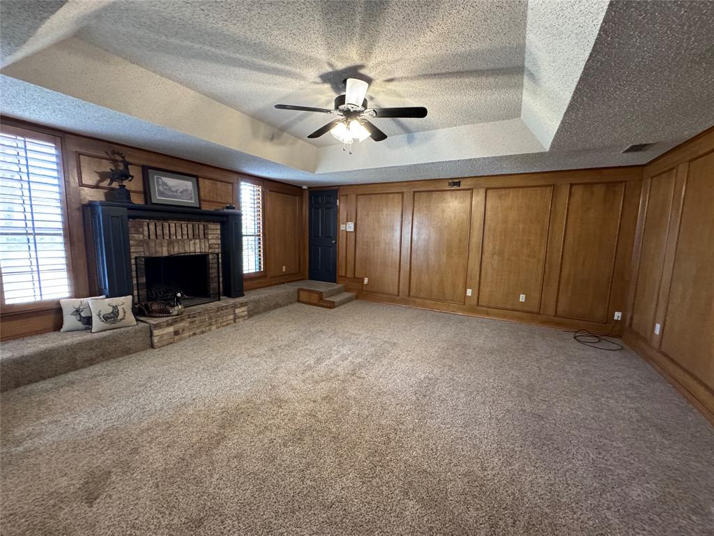 2202 Carriage Estates Road Sherman, TX 75092 - Photo 10 of 18 a view of an empty room with a fireplace and a window