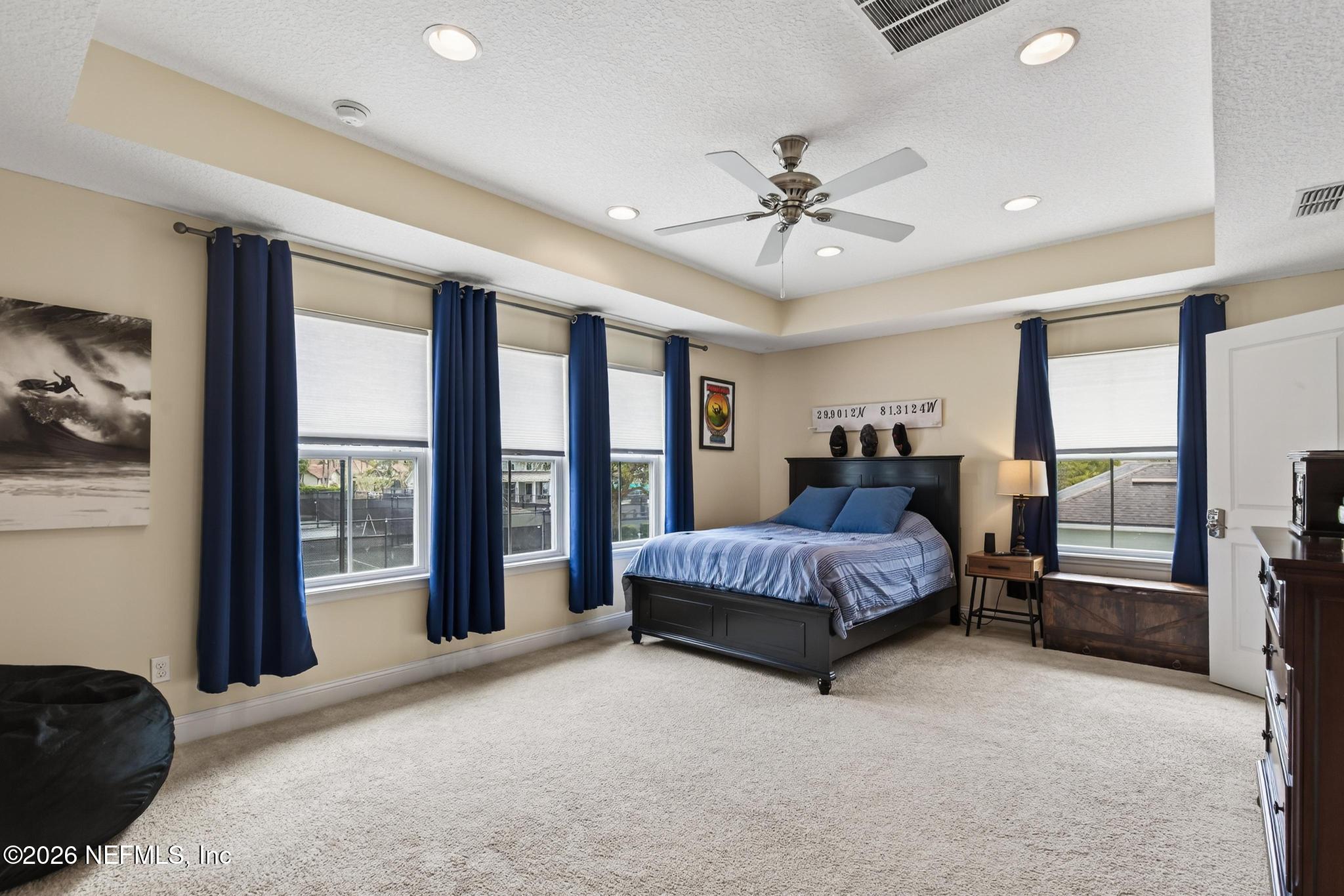 1906 North Loop Parkway St. Augustine, FL 32095 - Photo 16 of 87 a spacious bedroom with a large bed and a chandelier