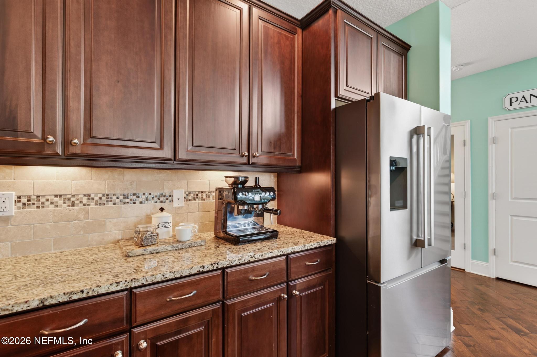 1906 North Loop Parkway St. Augustine, FL 32095 - Photo 27 of 87 a kitchen with granite countertop stainless steel appliances a refrigerator and a sink
