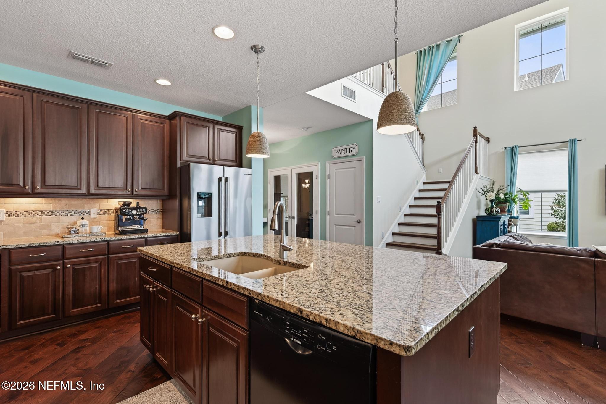 1906 North Loop Parkway St. Augustine, FL 32095 - Photo 28 of 87 a kitchen with stainless steel appliances granite countertop a sink a stove and a refrigerator