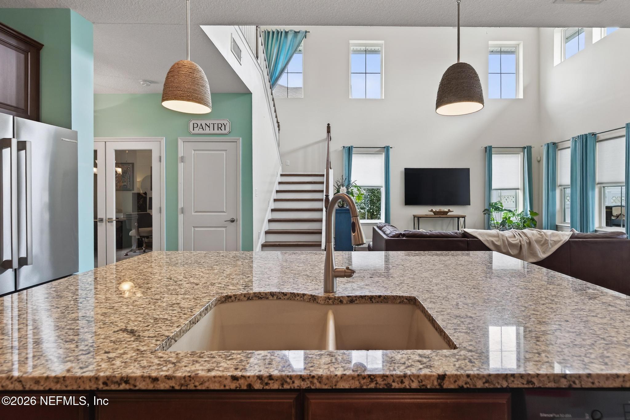 1906 North Loop Parkway St. Augustine, FL 32095 - Photo 29 of 87 a kitchen with kitchen island granite countertop a stove and a sink