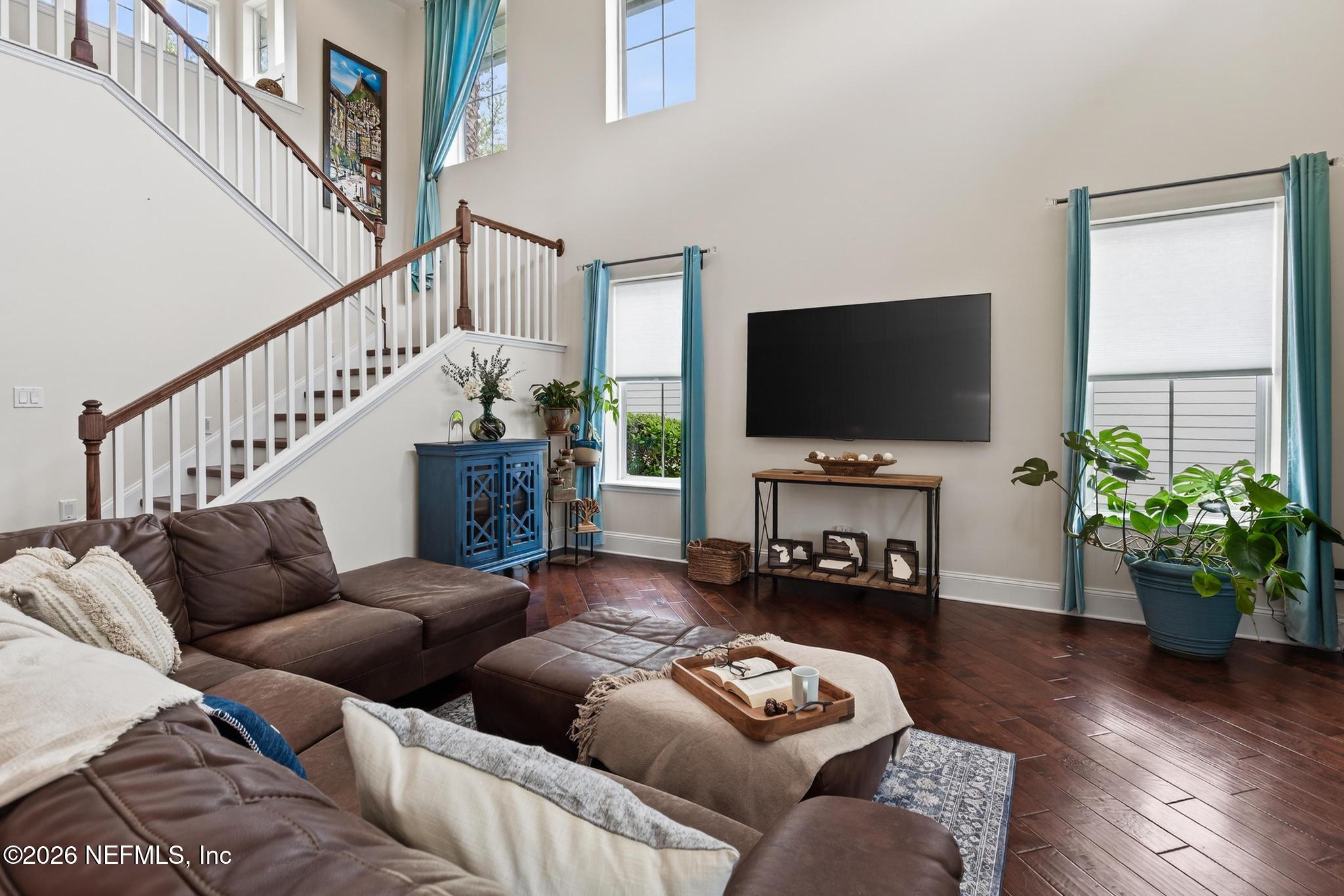 1906 North Loop Parkway St. Augustine, FL 32095 - Photo 5 of 87 a living room with furniture a flat screen tv and a potted plant