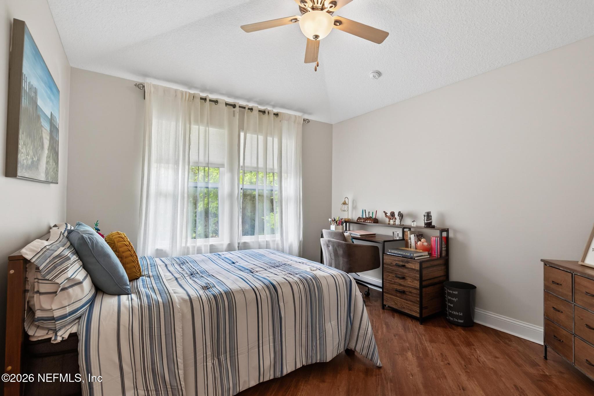 1906 North Loop Parkway St. Augustine, FL 32095 - Photo 54 of 87 a bedroom with a bed and a chandelier