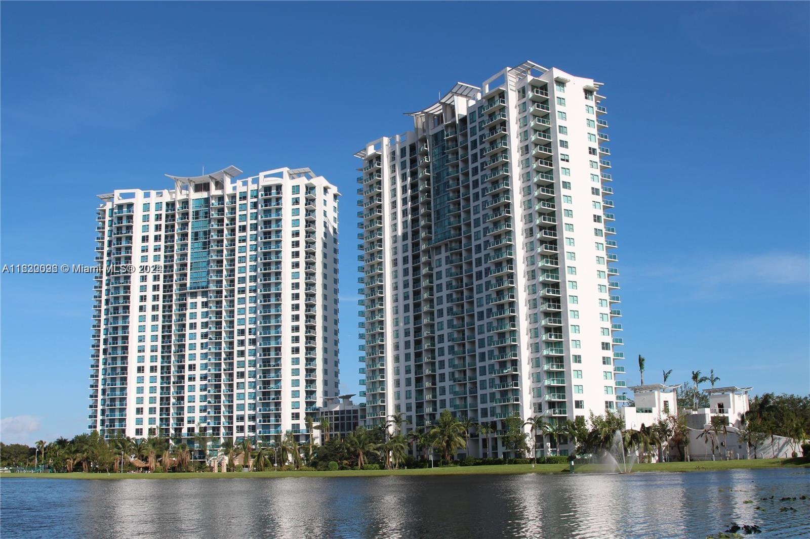 2641 North Flamingo Road, Unit 2007N Sunrise, FL 33323 - Photo 1 of 18 a view of a tall building next to a lake