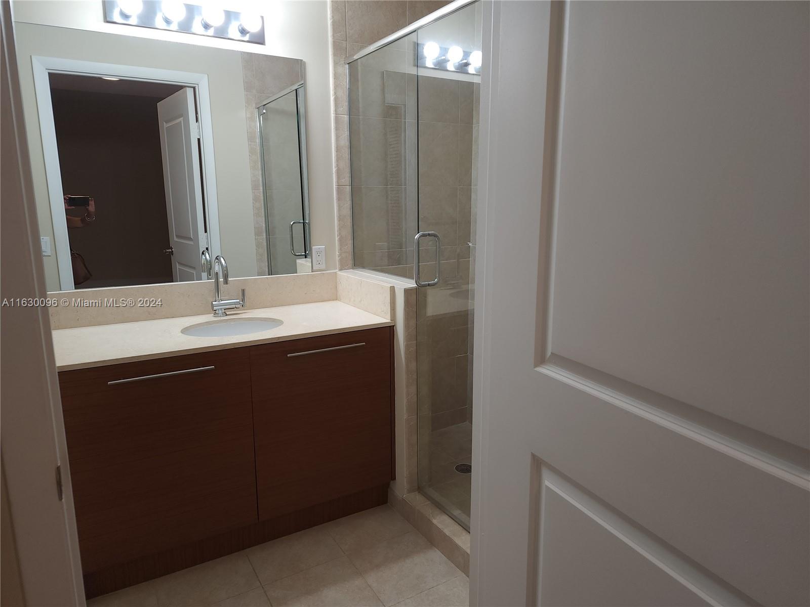 2641 North Flamingo Road, Unit 2007N Sunrise, FL 33323 - Photo 11 of 18 a room with a sink and a mirror
