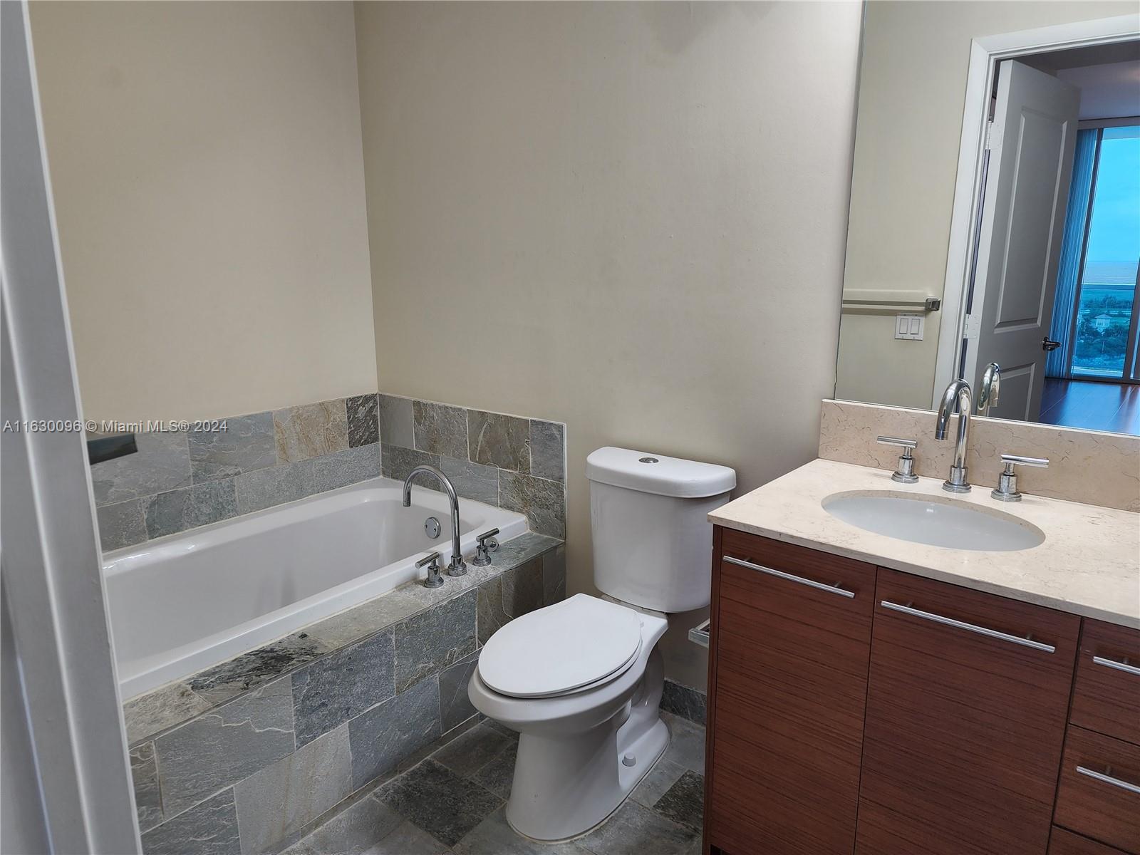 2641 North Flamingo Road, Unit 2007N Sunrise, FL 33323 - Photo 12 of 18 a bathroom with a sink toilet and bathtub