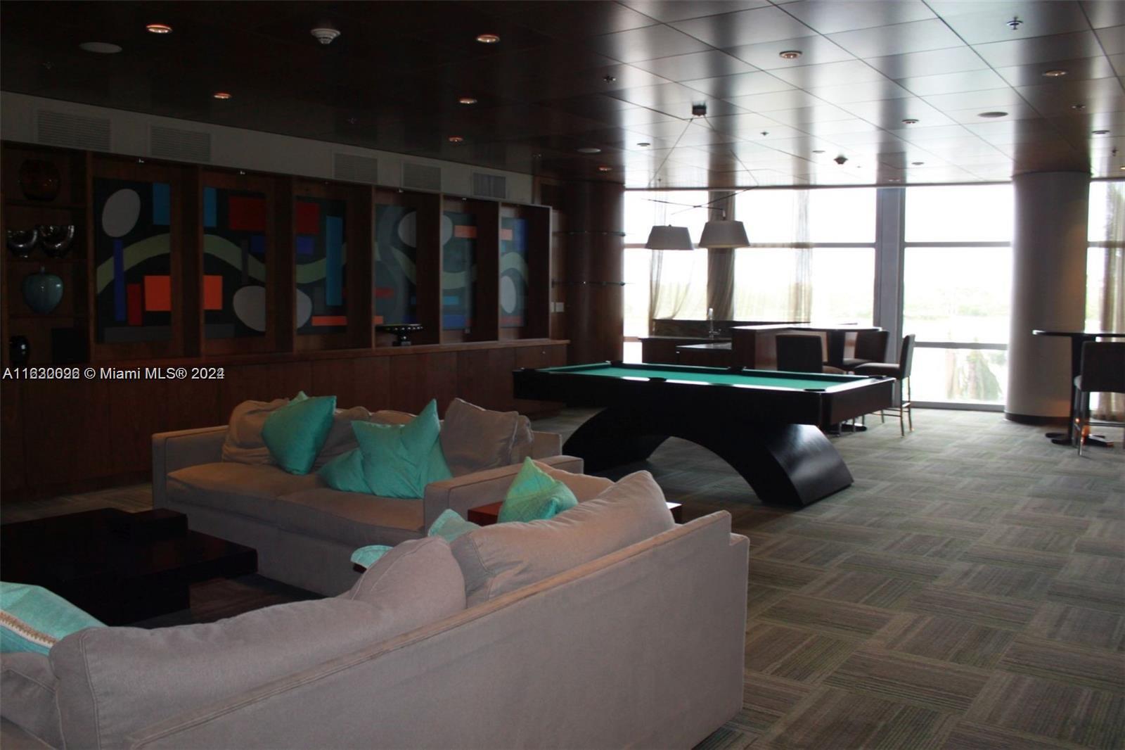 2641 North Flamingo Road, Unit 2007N Sunrise, FL 33323 - Photo 16 of 18 a living room with furniture and large windows