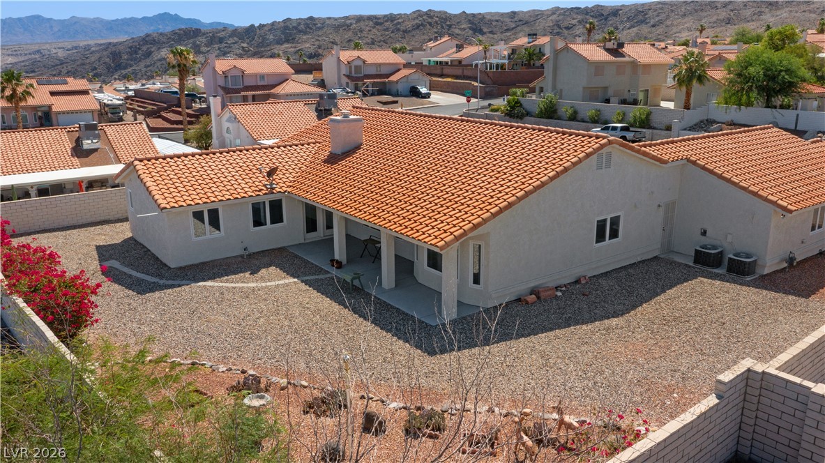 2055 Cholla Way Laughlin, NV 89029 - Photo 74 of 87 A terracotta-tiled roof crowns this residence, featuring a covered patio and a drought-resistant landscape.