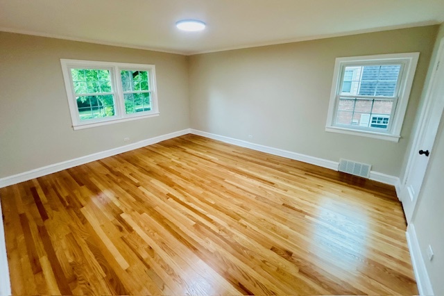 200 South Delaplaine Road Riverside, IL 60546 - Photo 12 of 21 a view of an empty room with wooden floor and a window