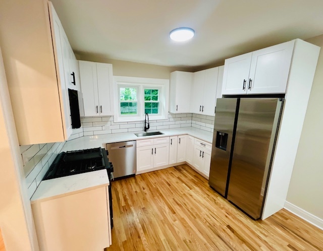 200 South Delaplaine Road Riverside, IL 60546 - Photo 8 of 21 a kitchen with a sink a refrigerator a window and cabinets