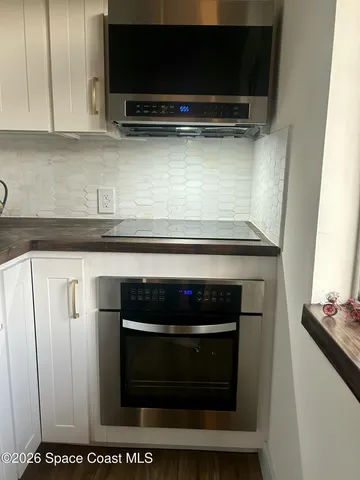 a kitchen with a refrigerator and a stove