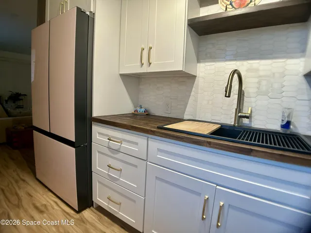 a large bed sitting in a bedroom next to a window