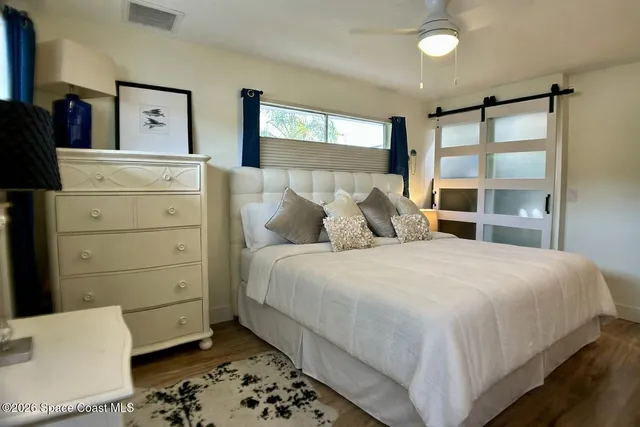 a bedroom with a bed and a television