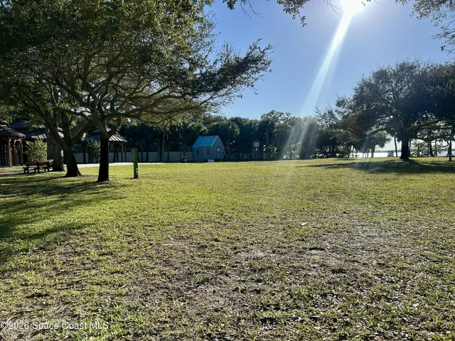 a view of outdoor space with garden and trees